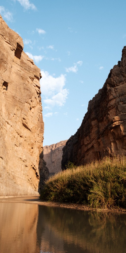 Santa Elena Canyon with still water reflecting the tall canyon walls.