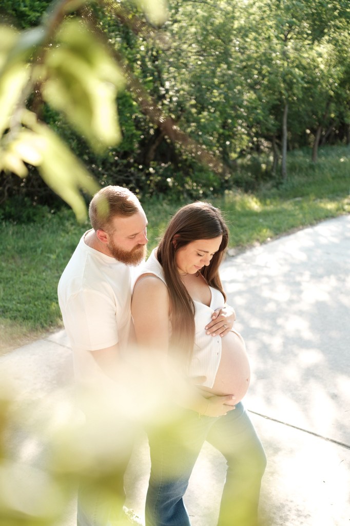 pregnant woman with husband sharing a moment together