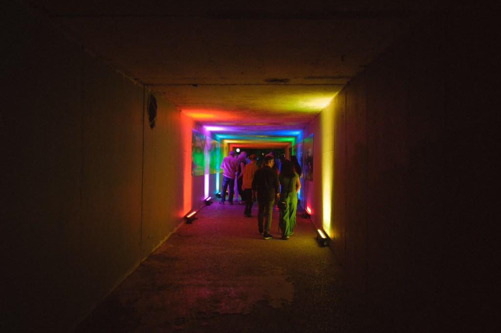 Visitors walking through illuminated art installation at Waller Creek photographed using Fuji X-T30 handheld.