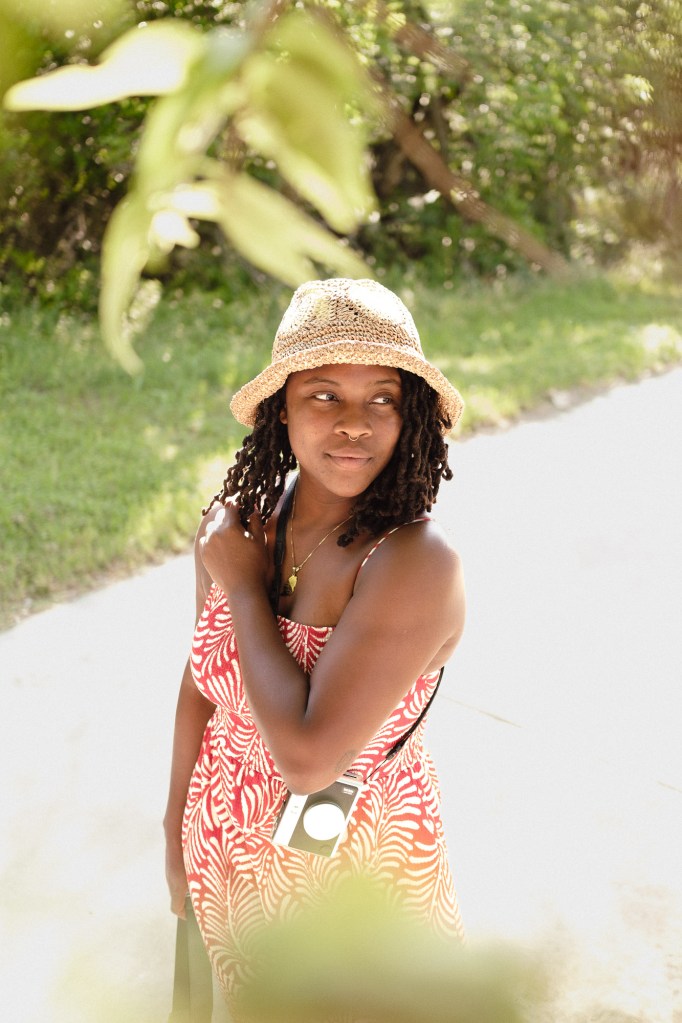 Backlit portrait of woman outdoors demonstrating bokeh from Viltrox 25mm f1.7 Air lens