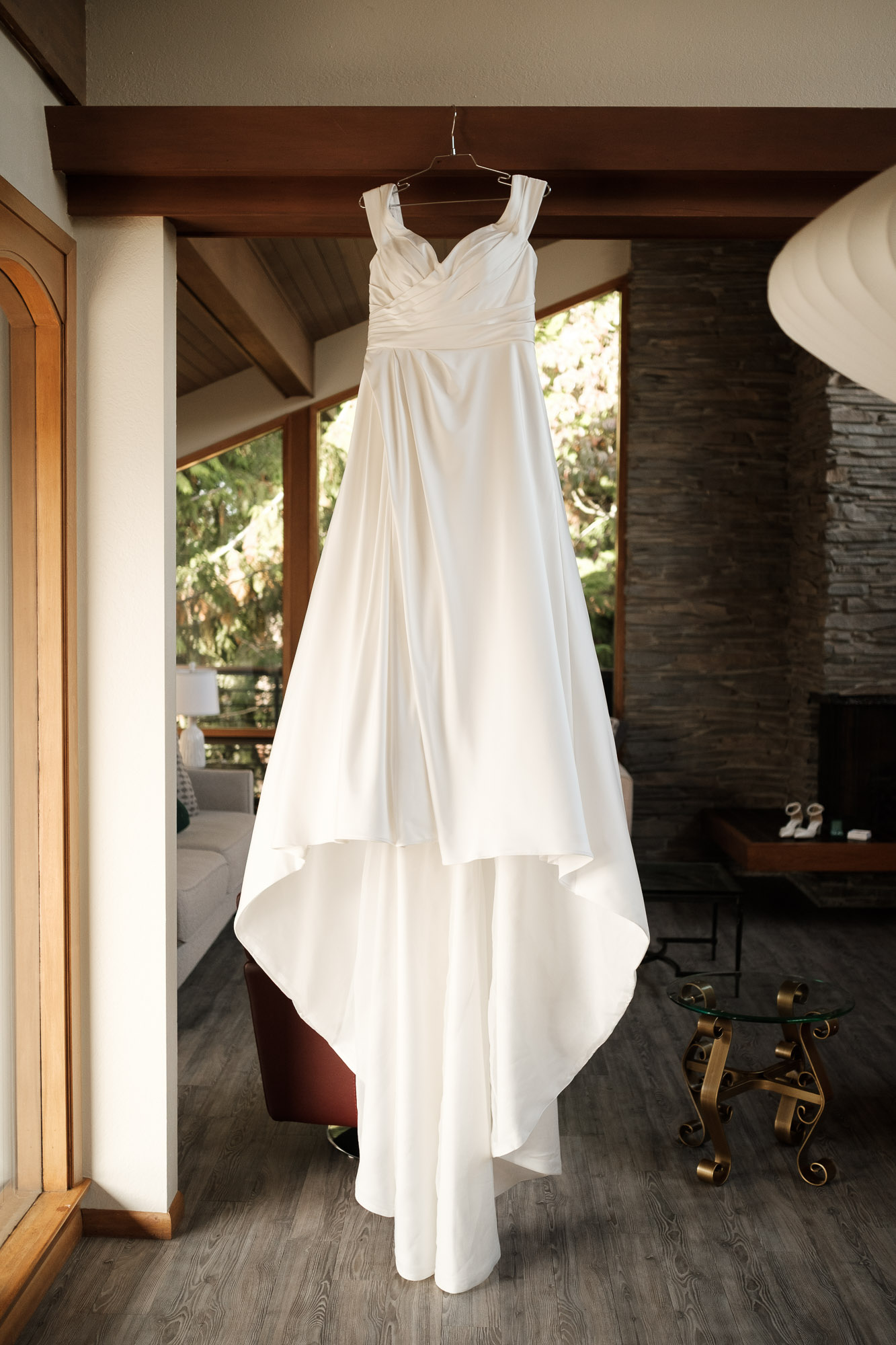 Bride’s wedding dress hanging inside a mid-century Airbnb in Seattle with soft natural window light.