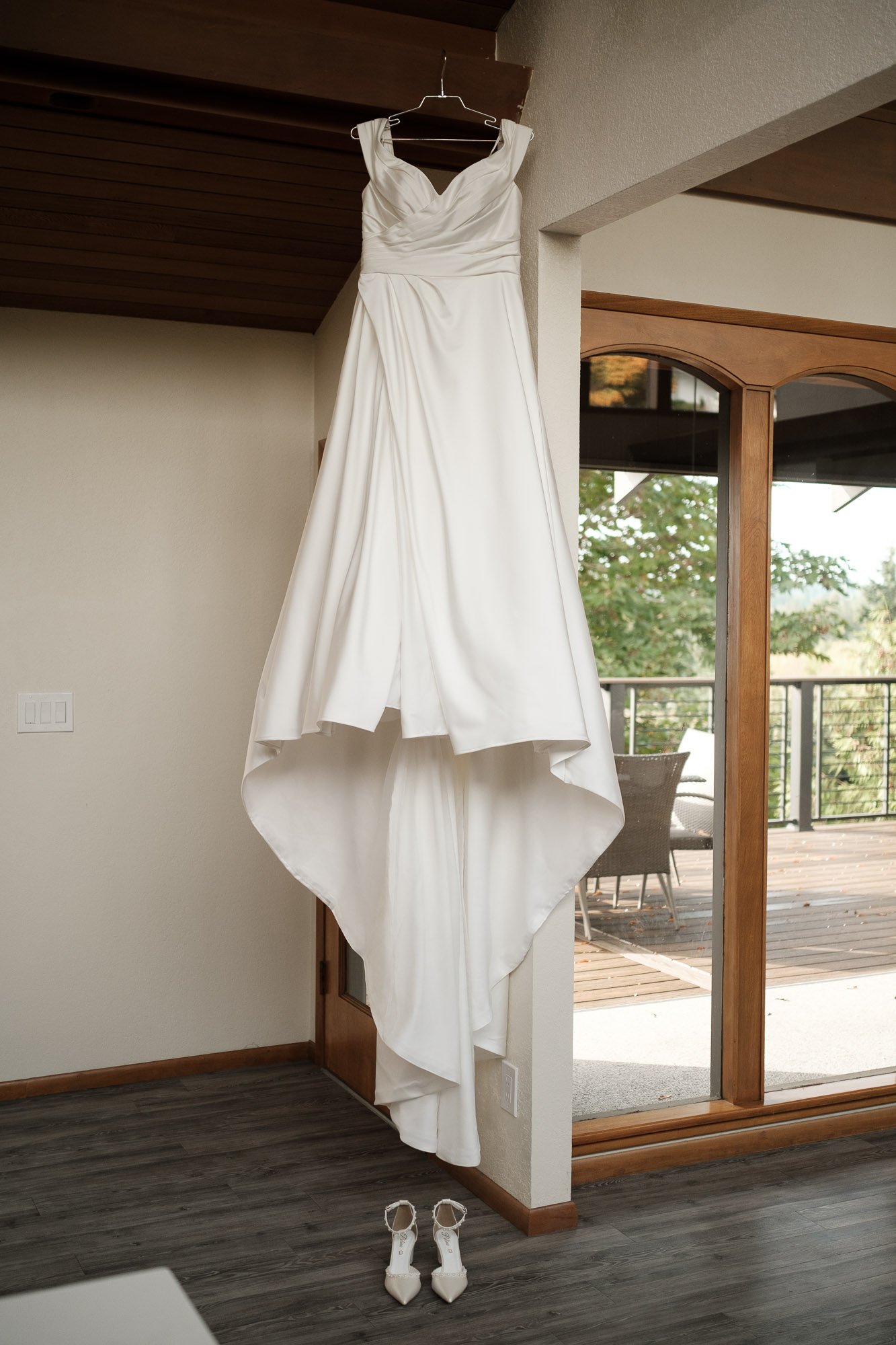 Bride’s wedding dress hanging inside a mid-century Airbnb in Seattle with soft natural window light.