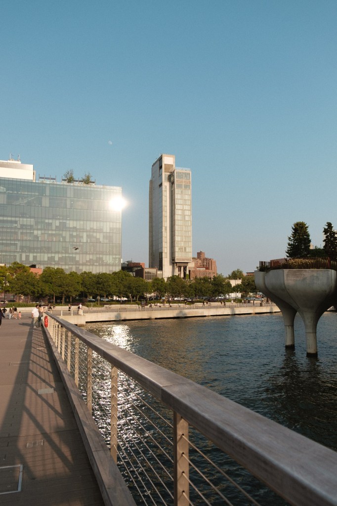 Modern glass building reflecting sunlight photographed using Fuji XF 18-55mm lens.