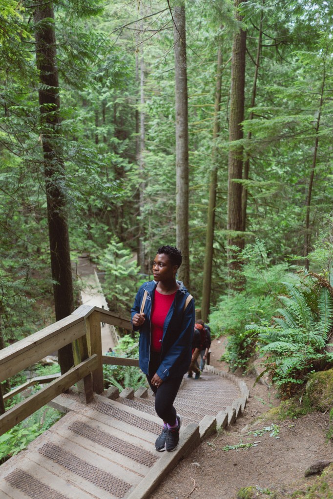 Woman standing on trail steps in Vancouver photographed using Sony FE 28mm F2.