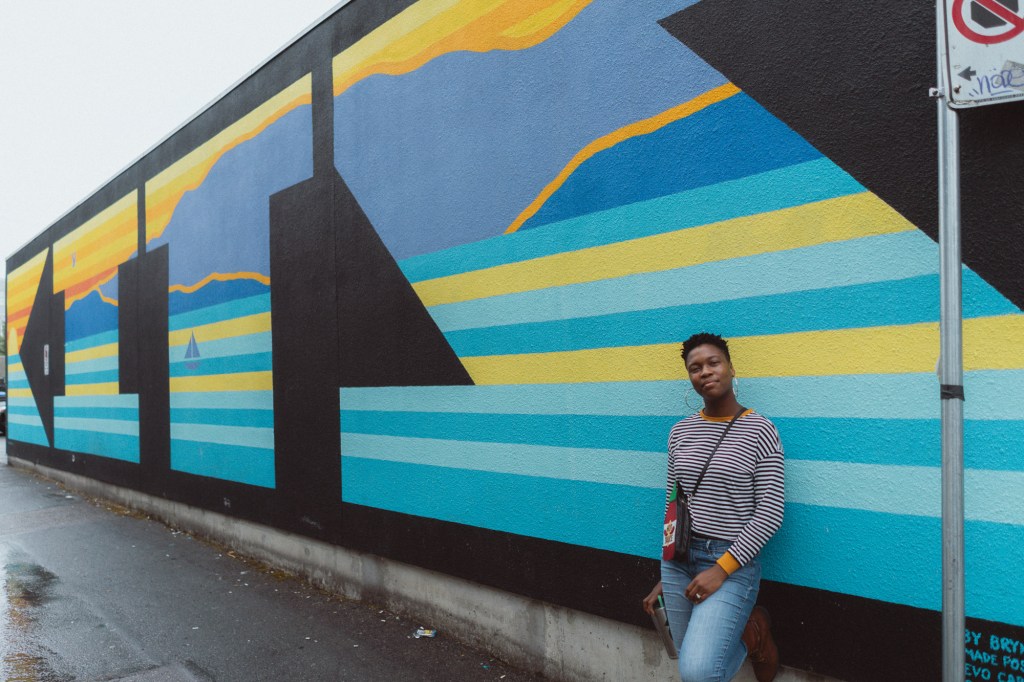 Candid moment of woman smiling in natural light captured with Sony A7 travel setup.