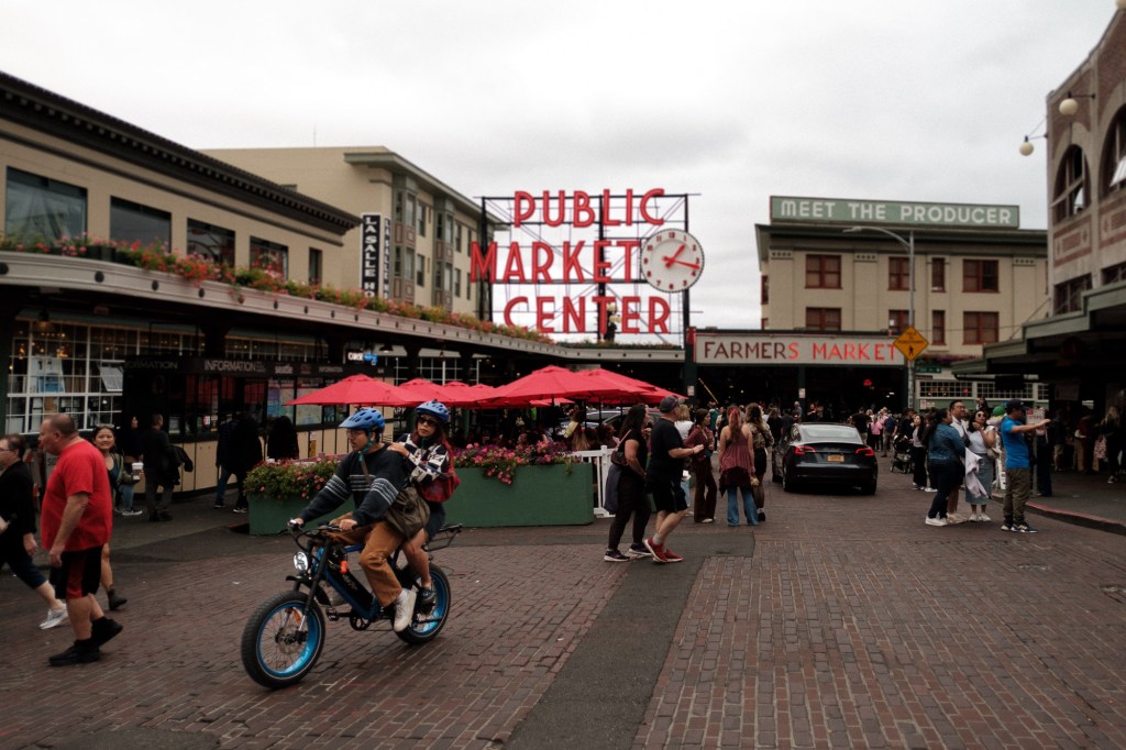 Couple riding a bike through Seattle street near Pike Place Market taken with Fuji X-T30