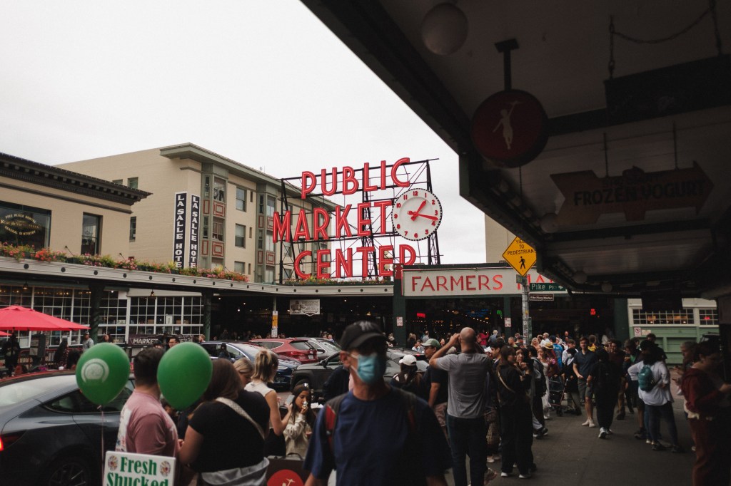 Pike Place Market entrance with crowd and storefronts photographed on Fuji X-T30 and XF 18mm f2