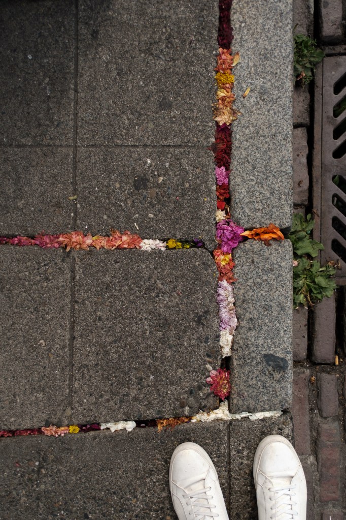 Pike Place Market sidewalk cracks stuffed with flowers