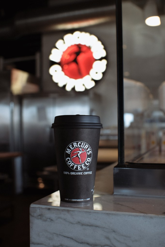 Close-up photo of coffee at Mercury's Coffee Co. with natural light and soft background blur.