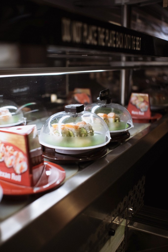Sushi plate at Kura Revolving Sushi Bar photographed in natural indoor light with shallow depth of field.