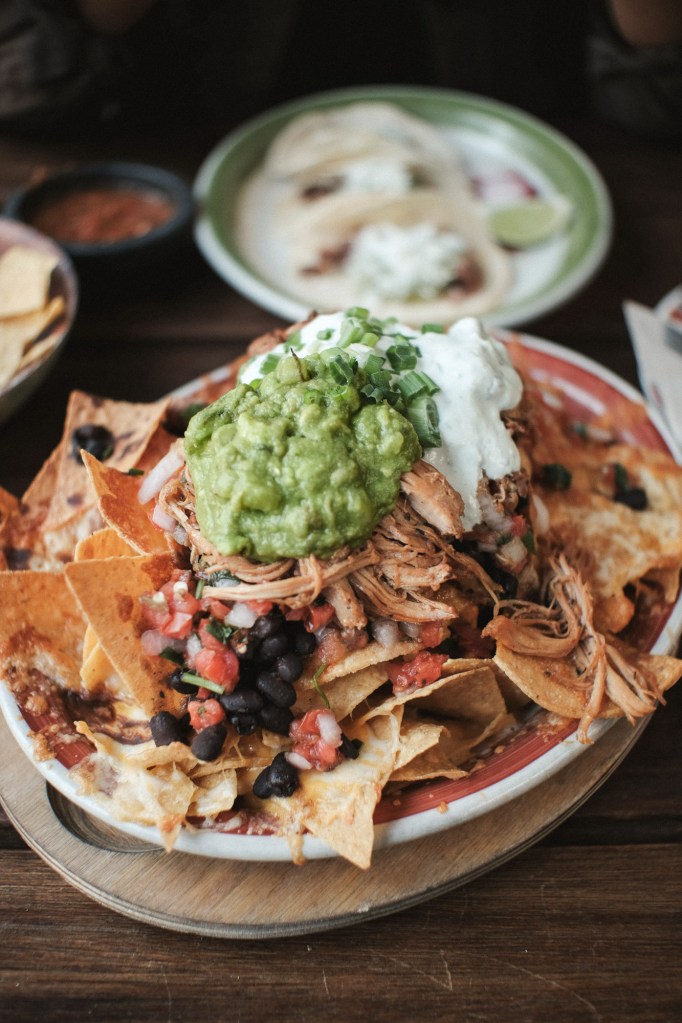 Plate of loaded nachos at Matador restaurant in Seattle photographed with natural light and shallow depth of field.
